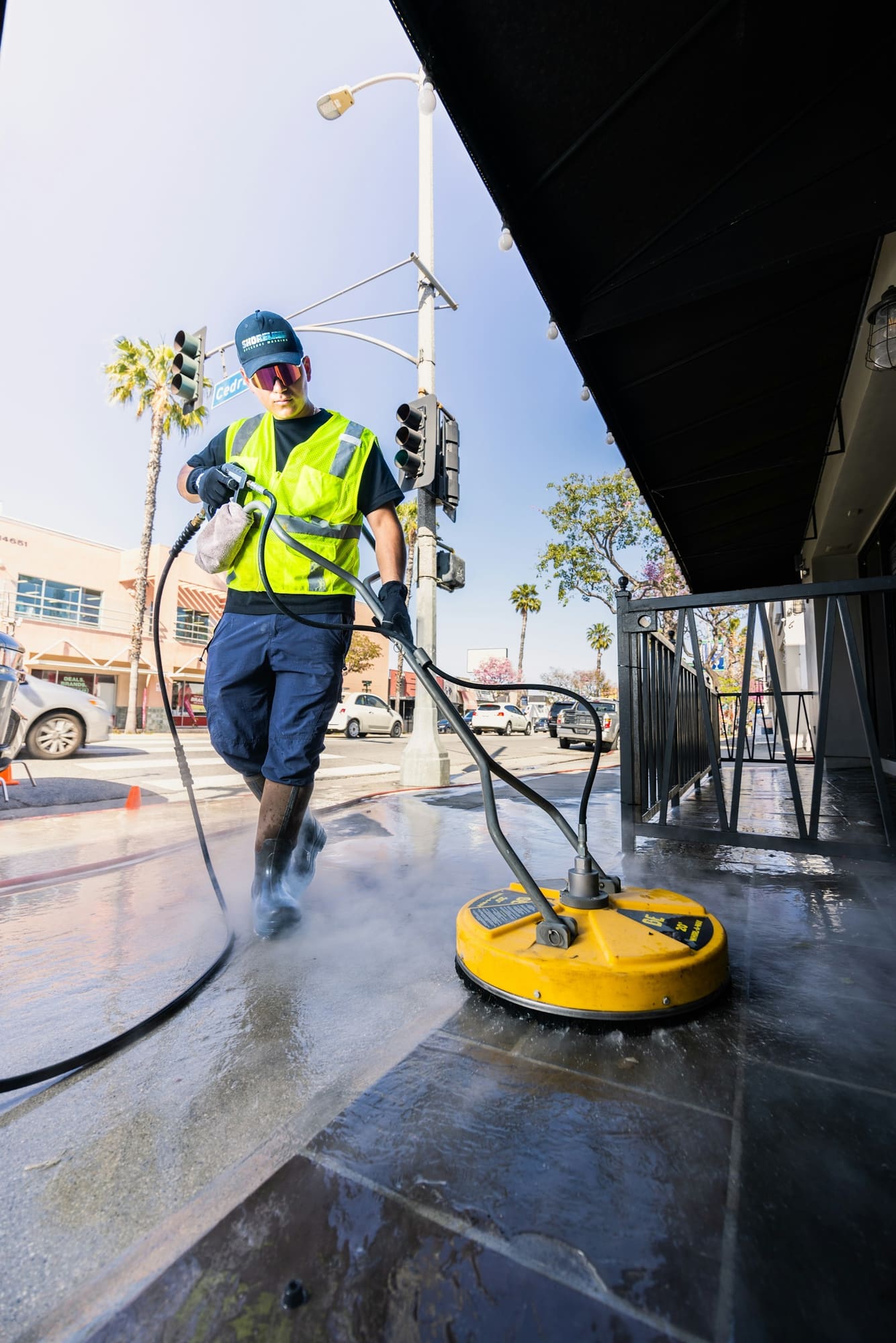 Stock photo: Technician operating a rotary pressure-washing surface cleaner