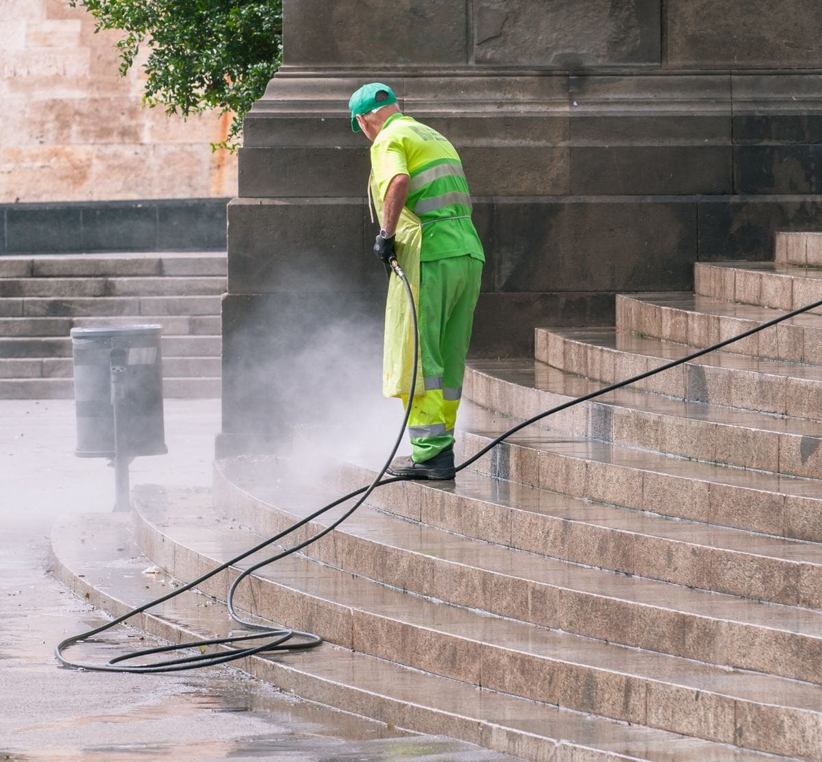 Stock photo: Worker pressure washing stone stairs