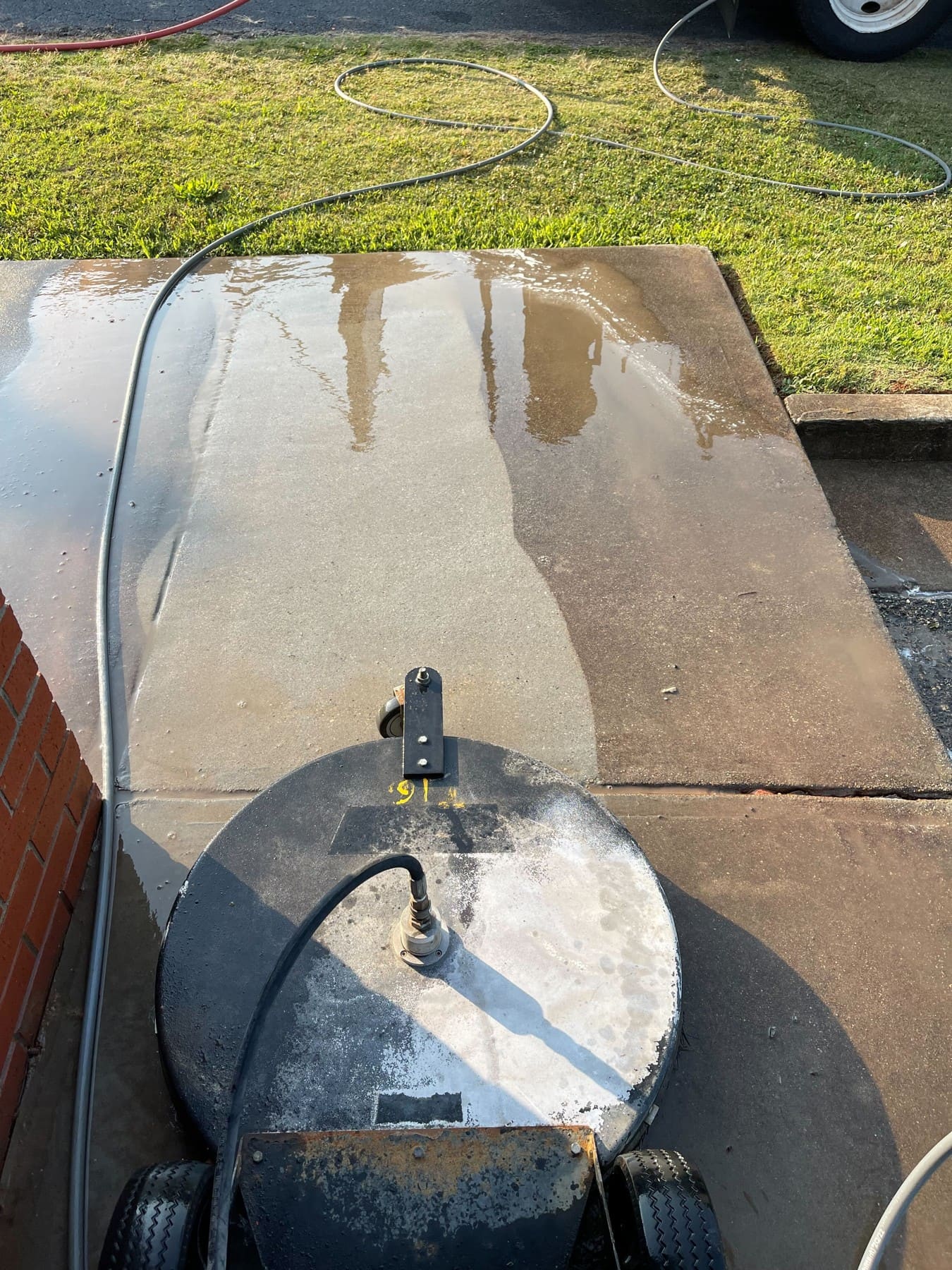 Stock photo: Surface cleaner washing a concrete driveway