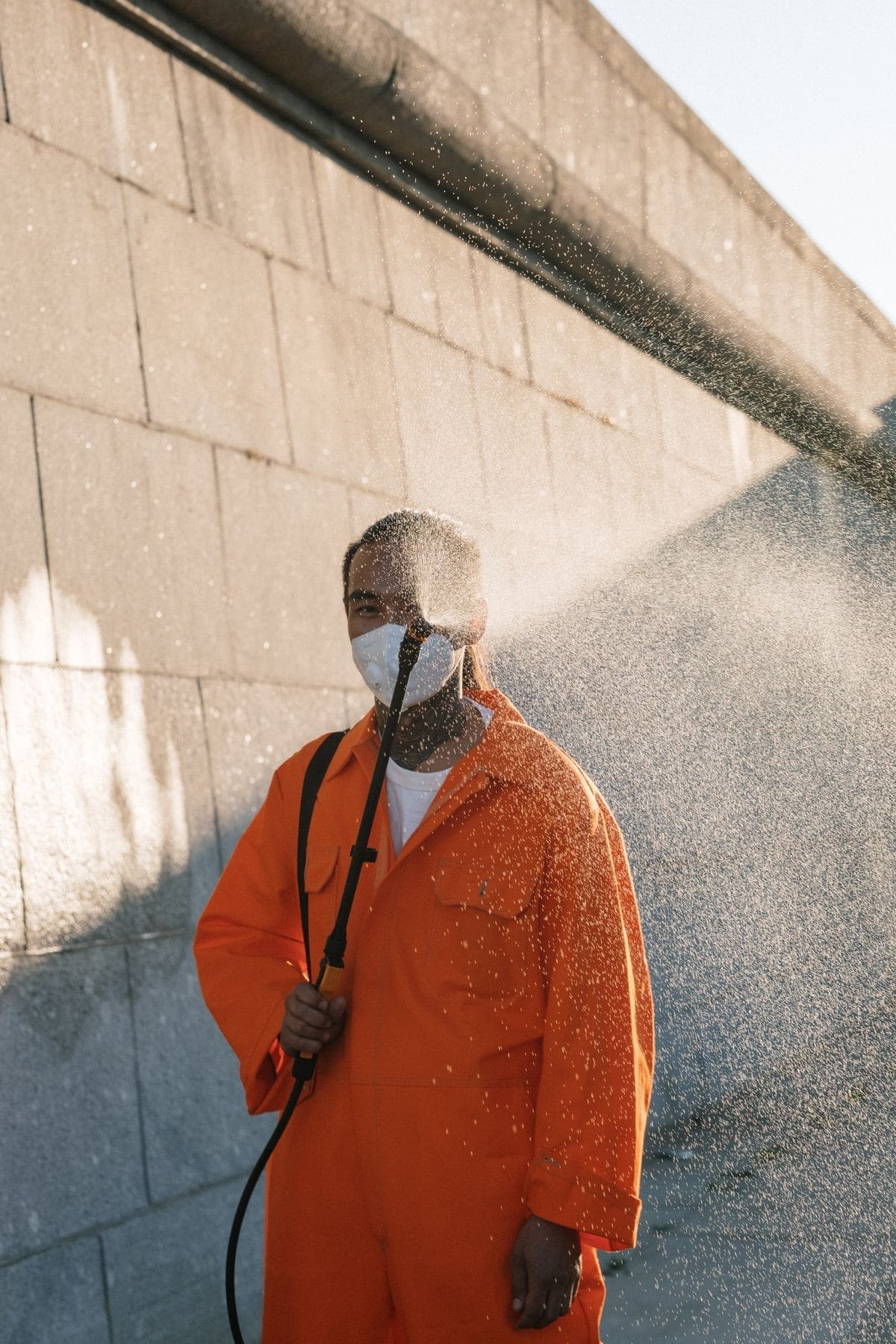Stock photo: Worker pressure washing a masonry wall