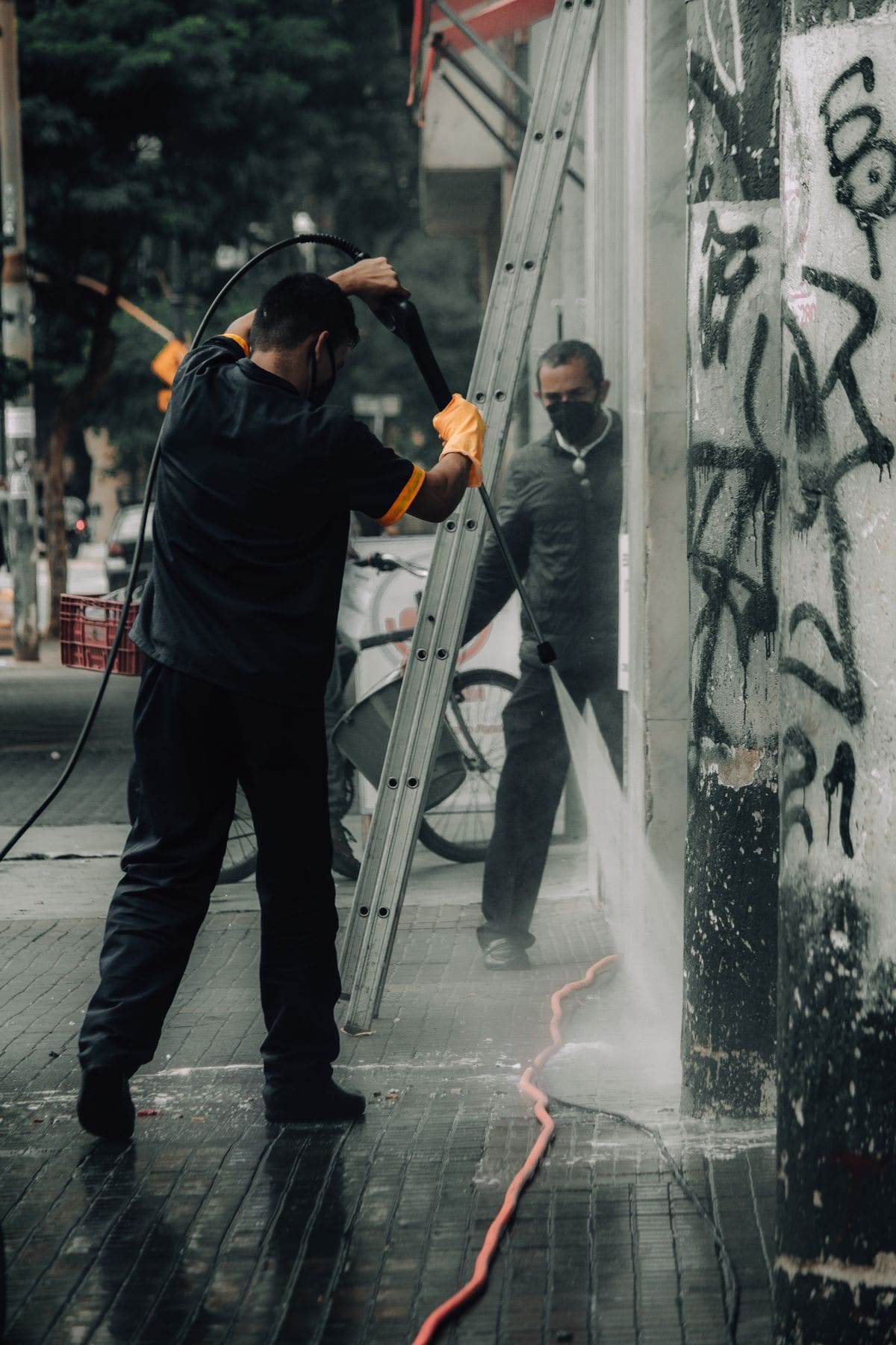 Stock photo: Workers pressure washing a building facade